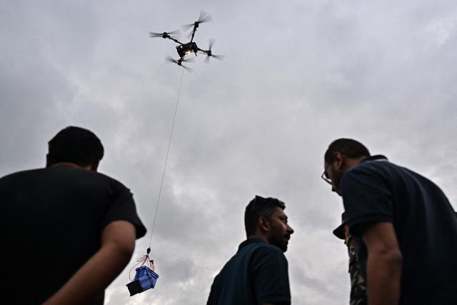 A drone carries relief supplies to a flood-affected area in Trishuli, Nepal's Nuwakot district on September 4, 2026. Devastating floods on the China-Nepal border have killed at least 1,287 people in Nepal, the disaster authority said September 4, with the number of missing at 5,083. (Photo by Pedro Pardo / AFP)