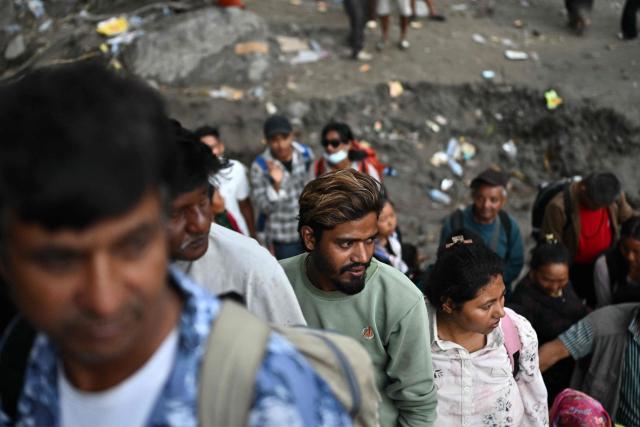 Locals wait to commute across the Trishuli River via an installed zip line in the aftermath of flash floods in Trishuli, Nepal's Nuwakot district on September 4, 2026. Devastating floods on the China-Nepal border have killed at least 1,287 people in Nepal, the disaster authority said September 4, with the number of missing at 5,083. (Photo by Pedro Pardo / AFP)