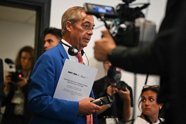 Reform UK Leader Nigel Farage carries a copy of a Memorandum of Understanding as he arrive for a joint press conference with President of French far-right party Rassemblement National (RN) Jordan Bardella (unseen), on the second day of the annual Reform UK party conference at the NEC in Birmingham, central England on September 4, 2026. (Photo by Oli SCARFF / AFP)