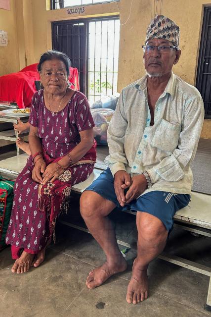Krishna Lal Chitrakar (R), who lost his house in flash floods, along with his family, takes shelter at a classroom inside a school in Devighat, Nepal's Nuwakot district, on September 4, 2026. Sheltering with relatives or in temporary camps, survivors of devastating floods in Nepal say they can no longer rebuild their homes after the landscape was violently transformed, leaving them focused simply on survival. (Photo by Lucie GODEAU / AFP)