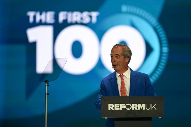 Reform UK Leader Nigel Farage reacts as a second set of protestors are removed from the building on the second day of the annual Reform UK party conference at the NEC in Birmingham, central England on September 4, 2026. (Photo by Paul ELLIS / AFP)