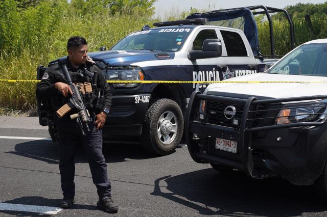 A Federal Police officer stands next to police vehicles near the scene where the body of Morena federal deputy Zenyazen Escobar was found inside a black Mercedes-Benz on the Veracruz-Xalapa highway near La Gloria, Veracruz state, Mexico, on September 4, 2026. The body of a Mexican federal lawmaker was found with a gunshot wound on a highway in the state of Veracruz, authorities said on September 4. Zenyazen Escobar was found inside his vehicle with a firearm nearby, the state's secretary of government told a press conference, declining to say whether the death was a suicide or the result of an attack. (Photo by Victoria Razo / AFP)