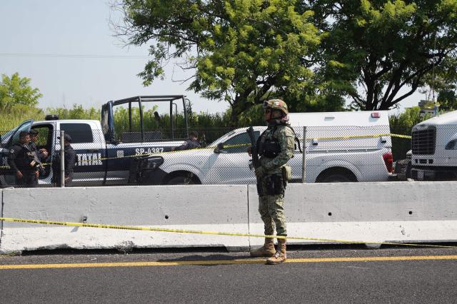 A Mexican Army soldier stands guard behind police tape near the scene where the body of Morena federal deputy Zenyazen Escobar was found inside a black Mercedes-Benz on the Veracruz-Xalapa highway near La Gloria, Veracruz state, Mexico, on September 4, 2026. The body of a Mexican federal lawmaker was found with a gunshot wound on a highway in the state of Veracruz, authorities said on September 4. Zenyazen Escobar was found inside his vehicle with a firearm nearby, the state's secretary of government told a press conference, declining to say whether the death was a suicide or the result of an attack. (Photo by Victoria Razo / AFP)