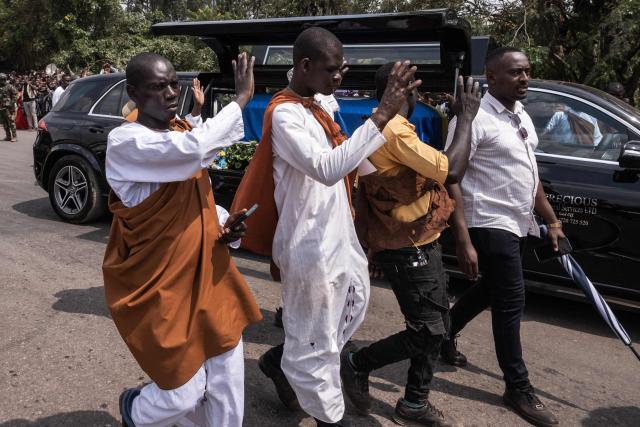 Members of the public react as the funeral procession carrying the remains of King Oyo Nyimba Kabamba Iguru Rukidi IV, who died in the United States on August 27, 2026 at the age of 34, makes its way to Karuziika Palace in Fort Portal, in the final stage of his journey home, on September 4, 2026. The body of Ugandan King Oyo Nyimba Kabamba Iguru Rukidi IV, recognised as the world's youngest reigning monarch, arrived back in Uganda following his death on August 27, 2026 in the United States at age 34. (Photo by Badru KATUMBA / AFP)