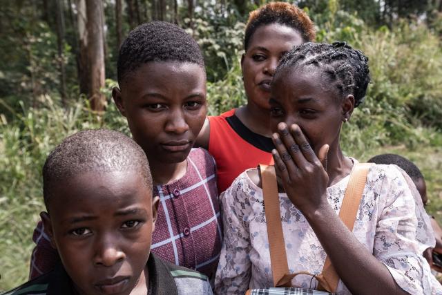 Members of the public react as the funeral procession carrying the remains of King Oyo Nyimba Kabamba Iguru Rukidi IV, who died in the United States on August 27, 2026 at the age of 34, makes its way to Karuziika Palace in Fort Portal, in the final stage of his journey home, on September 4, 2026. The body of Ugandan King Oyo Nyimba Kabamba Iguru Rukidi IV, recognised as the world's youngest reigning monarch, arrived back in Uganda following his death on August 27, 2026 in the United States at age 34. (Photo by Badru KATUMBA / AFP)