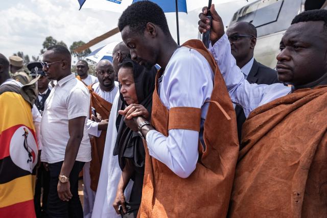 Members of the Tooro Kingdom royal family console Queen Mother Best Kemigisa Akiiki, the mother of the late King Oyo Nyimba Kabamba Iguru Rukidi IV, at Humura Playground in Kyegegwa on September 4, 2026. The body of Ugandan King Oyo Nyimba Kabamba Iguru Rukidi IV, recognised as the world's youngest reigning monarch, arrived back in Uganda following his death on August 27, 2026 in the United States at age 34. (Photo by Badru KATUMBA / AFP)