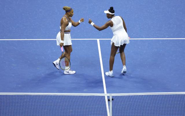 USA's Serena Williams (L) and Venus Williams bump fists their women's doubles first-round tennis match against Australia's Maya Joint and Taiwan's Chan Hao-ching on day six of the US Open tennis tournament at the USTA Billie Jean King National Tennis Center in New York City on September 4, 2026. (Photo by KENA BETANCUR / AFP)