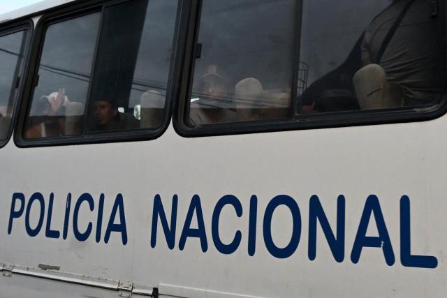 A group of detained fishermen are transported on a National Police bus to the Community Surveillance Unit (UVC) from the port of Manta, Ecuador, on September 4, 2026. The US military said on September 4 that it had blown up another boat allegedly linked to Ecuadoran drug gangs, bringing to three the number of vessels it has sunk in the area in the past week. (Photo by ARIEL OCHOA / AFP)