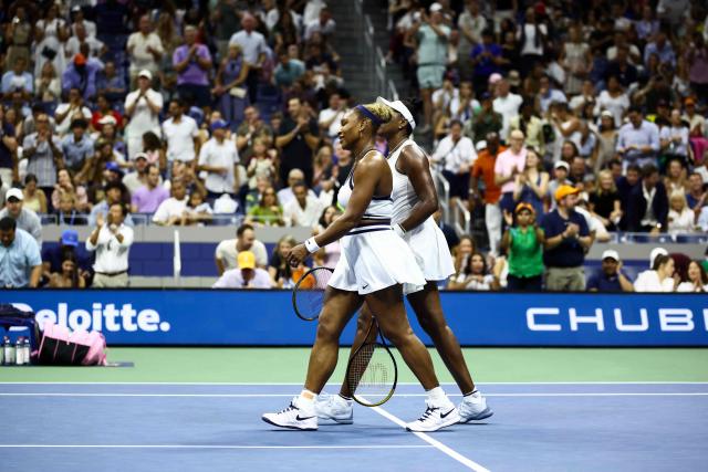 USA's Venus Williams (L) and her sister Serena Williams (R) walk to the net after losing their women's doubles first-round tennis match against Australia's Maya Joint and Taiwan's Chan Hao-ching on day six of the US Open tennis tournament at the USTA Billie Jean King National Tennis Center in New York City on September 4, 2026. (Photo by CHARLY TRIBALLEAU / AFP)