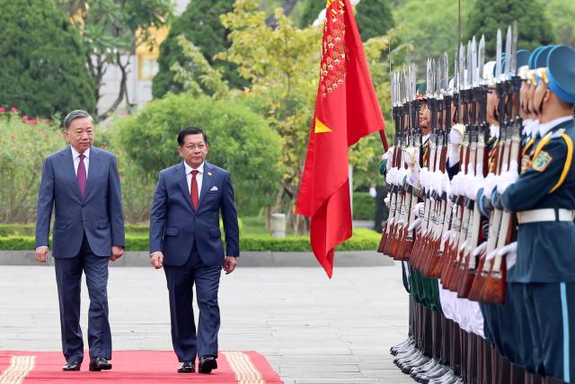 Vietnam's President To Lam (L) and Myanmar's President Min Aung Hlaing review the guard of honour during a welcoming ceremony at the National Assembly House in Hanoi on September 5, 2026. (Photo by Quang Nguyen / AFP)