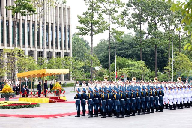 Vietnam's President To Lam (L, on podium) and Myanmar's President Min Aung Hlaing review the guard of honour during a welcoming ceremony at the National Assembly House in Hanoi on September 5, 2026. (Photo by Quang Nguyen / AFP)