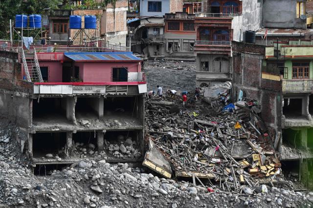 Flash flood survivors look for salvageable belongings at Trishuli Bazar in Nepal's Nuwakot district on September 5, 2026. Devastating floods on the China-Nepal border have killed at least 1,287 people in Nepal, the disaster authority said September 4, with the number of missing at 5,083. (Photo by Prakash MATHEMA / AFP)