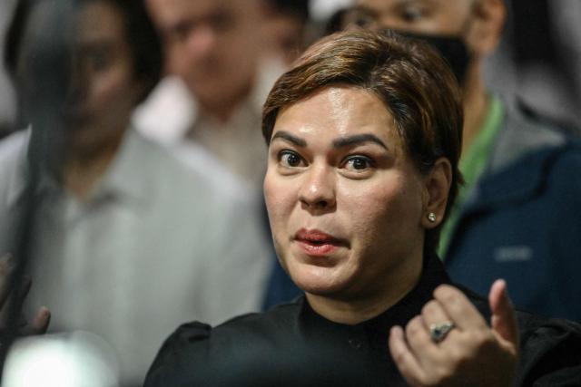 Philippine Vice President Sara Duterte talks to members of the media after posting bail at a court building in Quezon City suburban Manila on September 5, 2026. A Philippine court on September 4 issued an arrest warrant for Vice President Sara Duterte over an alleged death threat against the country's president, with her defence team saying she would "exercise all her legal remedies". (Photo by Ted ALJIBE / AFP)