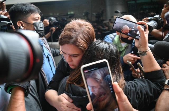 Philippine Vice President Sara Duterte (C) embraces a supporter after posting bail at a court building in Quezon City suburban Manila on September 5, 2026. A Philippine court on September 4 issued an arrest warrant for Vice President Sara Duterte over an alleged death threat against the country's president, with her defence team saying she would "exercise all her legal remedies". (Photo by Ted ALJIBE / AFP)