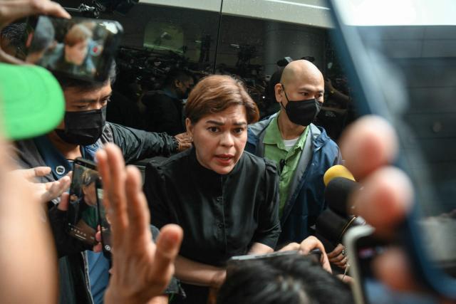 Philippine Vice President Sara Duterte (C) talks to her supporters after posting bail at a court building in Quezon City suburban Manila on September 5, 2026. A Philippine court on September 4 issued an arrest warrant for Vice President Sara Duterte over an alleged death threat against the country's president, with her defence team saying she would "exercise all her legal remedies". (Photo by Ted ALJIBE / AFP)