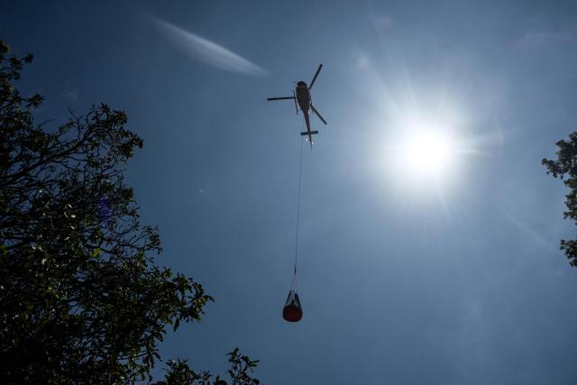 A helicopter transports relief materials in the aftermath of flash floods at Trishuli Bazar in Nepal's Nuwakot district on September 5, 2026. Devastating floods on the China-Nepal border have killed at least 1,287 people in Nepal, the disaster authority said September 4, with the number of missing at 5,083. (Photo by Prakash MATHEMA / AFP)