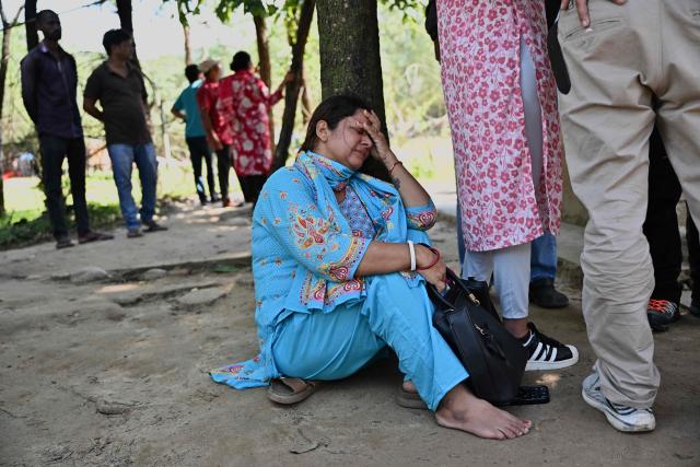 A relative of a missing flash flood victim reacts outside a temporary relief camp at Trishuli Bazar in Nepal's Nuwakot district on September 5, 2026. Devastating floods on the China-Nepal border have killed at least 1,287 people in Nepal, the disaster authority said September 4, with the number of missing at 5,083. (Photo by Pedro Pardo / AFP)
