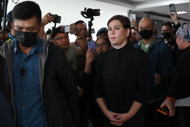 Philippine Vice President Sara Duterte (front R) leaves court after posting bail in Quezon City, suburban Manila on September 5, 2026. Philippine Vice President Sara Duterte posted bail at a Manila courthouse on May 5, a day after an arrest warrant was issued over her alleged death threat against the country's president. (Photo by Ted ALJIBE / AFP)