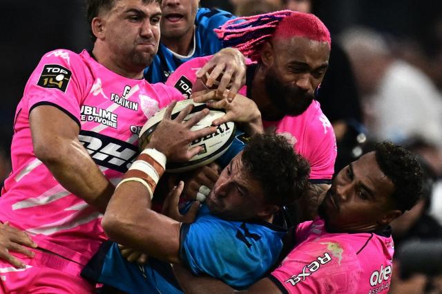 (FILES) Montpelliers Australian full-back Tom Banks is tackled by Stade Français' South African center Jeremy Ward (L), Stade Français' Fijian winger Peniasi Dakuwaqa (C) and Stade Français' French center Noah Nene (R) during the French Top14 rugby union semi-final match between Montpellier Hérault Rugby and Stade Français at the Velodrome stadium in Marseille, southern France, on June 20, 2026. Centre Noah Nene, who had his first selection with the France XV during the 2026 Six Nations Tournament, extended his contract with Stade français until 2031, the club announced on the evening of September 4, 2026. (Photo by Miguel MEDINA / AFP)