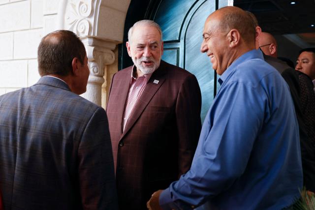 US Ambassador to Israel Mike Huckabee (C) shares a light moment with his host, as he departs following a visit to the home of the American-Palestinian resident who has previously been twice attacked and faces ongoing harassment from Israeli settlers, in the Israeli-occupied West Bank town of Turmus Ayya, about 23 kilometres (14 miles) northeast of Ramallah, where a large proportion of the town's residents hold dual nationality, on September 5, 2026. Attacks by Israeli settlers on the Palestinian village of Qusra drew unusually strong criticism from the US ambassador on September 3, 2026, while Britain's foreign secretary vowed a tough response to "appalling" violence by Israeli settlers against Palestinians. All Israeli settlements in the West Bank, which has been occupied since 1967, are illegal under international law. (Photo by John Wessels / AFP)