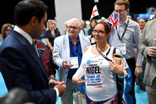 A delegate shows their top to Reform UK's shadow Home Secretary Zia Yusuf on the third day of the annual Reform UK party conference at the NEC in Birmingham, central England on September 5, 2026. (Photo by Oli SCARFF / AFP)