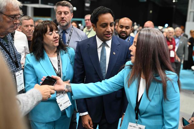 Delegates meet Reform UK's shadow Home Secretary Zia Yusuf as they arrive on the third day of the annual Reform UK party conference at the NEC in Birmingham, central England on September 5, 2026. (Photo by Oli SCARFF / AFP)