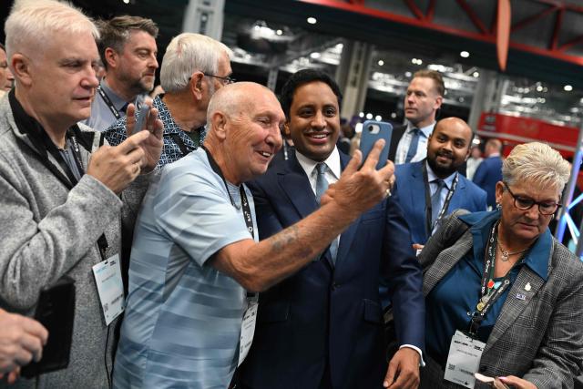 Reform UK's shadow Home Secretary Zia Yusuf poses for a photo with delegates on the third day of the annual Reform UK party conference at the NEC in Birmingham, central England on September 5, 2026. (Photo by Oli SCARFF / AFP)