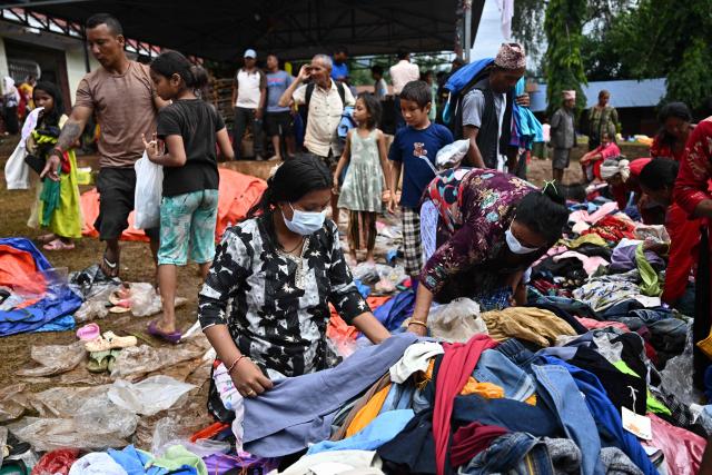 Flash flood survivors collect aid from a temporary relief centre at Devghat in Nepal's Nuwakot district on September 5, 2026. (Photo by Pedro PARDO / AFP)