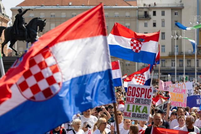 Protesters wave national flags on Ban Jelacic Square during a demonstration to demand action over the illegal dumping of hazardous waste in Croatia's Lika region, in Zagreb, on September 7, 2026. Thousands rallied in Zagreb seeking an immediate cleanup of thousands of tonnes of hazardous waste still unrecovered after years of illegal dumping in one of the country's most pristine regions, and to demand accountability for those responsible. (Photo by MARKO PERKOV / AFP)