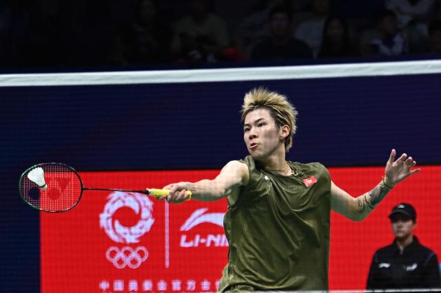 Hong Kong's Lee Cheuk Yiu hits a return to France's Christo Popov during their men's singles semi-final match at the 2026 China Masters badminton tournament in Shenzhen, southern China's Guangdong province on September 5, 2026. (Photo by CN-STR / AFP) / China OUT