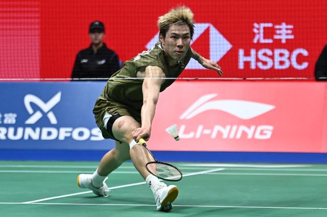 Hong Kong's Lee Cheuk Yiu hits a return to France's Christo Popov during their men's singles semi-final match at the 2026 China Masters badminton tournament in Shenzhen, southern China's Guangdong province on September 5, 2026. (Photo by CN-STR / AFP) / China OUT