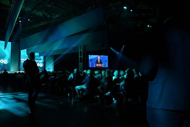 Security guards patrol as Reform UK Chairman and Chief Whip Lee Anderson delivers a speech on the third day of the annual Reform UK party conference at the NEC in Birmingham, central England on September 5, 2026. (Photo by Paul ELLIS / AFP)