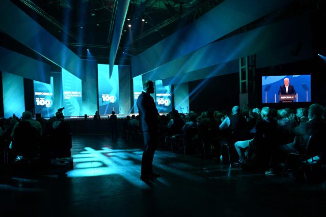 A security guard patrols as Reform UK Chairman and Chief Whip Lee Anderson delivers a speech on the third day of the annual Reform UK party conference at the NEC in Birmingham, central England on September 5, 2026. (Photo by Paul ELLIS / AFP)