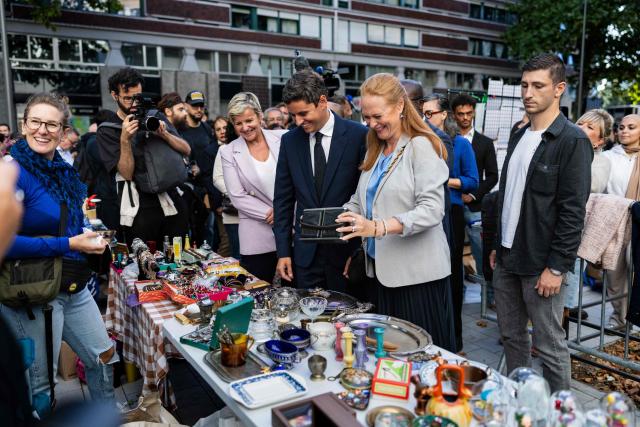 General Secretary of French centrist party Renaissance and 2027 presidential candidate Gabriel Attal (C) and Ensemble pour la Republique MP Violette Spillebout (C,R), a member of Attal's presidential campaign team, react as they visit the Braderie de Lille flea market in Lille, northern France on September 5, 2026. (Photo by Sameer Al-DOUMY / AFP)