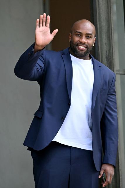 (FILES) French judoka Teddy Riner waves as he leaves after a reception at the Elysee presidential palace in Paris on June 1, 2025, a day after PSG won the 2025 UEFA Champions League final football match against Inter Milan in Munich. Teddy Riner, who was due to take part in the World Judo Championships next month, was forced to withdraw due to a shoulder injury, the French Federation announced on September 5, 2026. (Photo by LOU BENOIST / AFP)