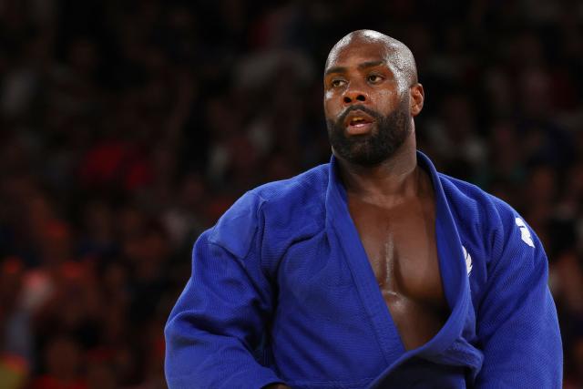 (FILES) France's Teddy Riner celebrate after beating Japan's Tatsuru Saito in the judo mixed team gold medal bout between Japan and France at the Paris 2024 Olympic Games in the Champ-de-Mars Arena, in Paris on August 3, 2024. Teddy Riner, who was due to take part in the World Judo Championships next month, was forced to withdraw due to a shoulder injury, the French Federation announced on September 5, 2026. (Photo by Jack GUEZ / AFP)