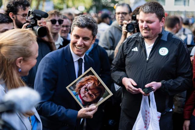 General Secretary of French centrist party Renaissance and upcoming presidential election candidate Gabriel Attal (C) reacts as he visits the Braderie de Lille flea market in Lille, northern France on September 5, 2026. (Photo by Sameer Al-DOUMY / AFP)
