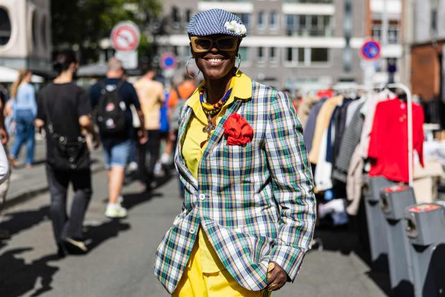 A woman poses for a picture during the Braderie de Lille flea market in Lille, northern France on September 5, 2025. (Photo by Sameer Al-DOUMY / AFP)