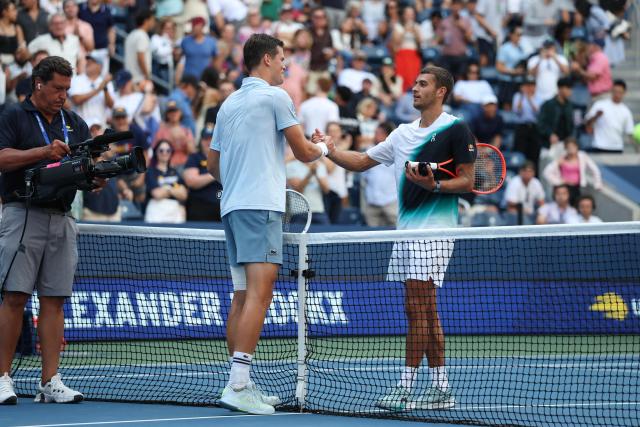 (L/R) Belgium's Alexander Blockx greets Italy's Flavio Cobolli at the net after Blockx won their men's singles third round tennis match on day seven of the US Open tennis tournament at the USTA Billie Jean King National Tennis Center in New York City on September 5, 2026. (Photo by TIMOTHY A. CLARY / AFP)