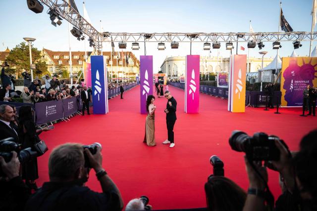 US actress Sophie Thatcher (L) and danish film director Nicolas Winding Refn (R) pose in front of photographers on the red carpet during the 52nd edition of the Deauville American film festival, in Deauville, northwestern France on September 5, 2026. (Photo by Guillaume SALIGOT / AFP)