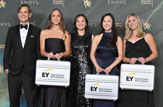 (From L) Ernst & Young partner Paul Chen, risk consulting manager Greta Casagrande, global payroll operator Sheri Dear, senior technology risk consultant Sophia Song and assurance senior manager Paige Zimmer carry suitcases containing the names of the winners ahead of Night One of the 78th Emmy Awards at the Peacock Theater in Los Angeles on September 5, 2026. (Photo by LISA O`CONNOR / AFP)