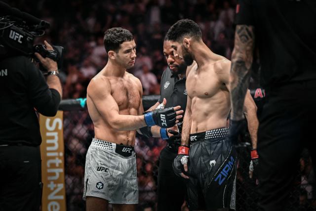 France's Axel Sola (L) offers a hands shake after defeating France's Fares Ziam (R) in their mixed martial arts (MMA) fight at the 5th edition of the Ultimate Fighting Championship (UFC) at the Bercy Accor Arena, in Paris, on September 5, 2026. (Photo by LOU BENOIST / AFP)