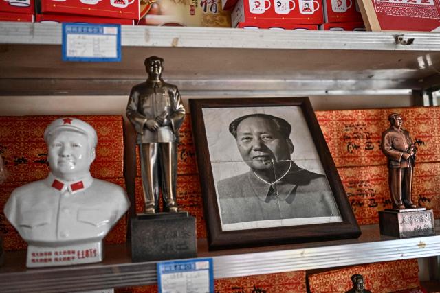 This picture taken on August 19, 2026 shows objects with the image of the late Communist leader Mao Zedong displayed for sale in a souvenir shop in Dazhai, in northern China's Shanxi province. In the ruling Communist Party's telling, Mao remains the revolutionary hero -- his face on banknotes, his portrait overlooking Tiananmen Square, and his body preserved in a mausoleum. (Photo by Pedro PARDO / AFP) / TO GO WITH: China-Mao-anniversary, by Sam DAVIES