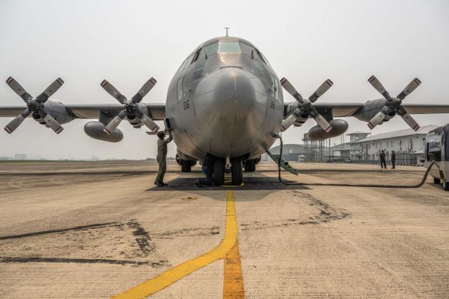 A member of the Royal Malaysian Air Force inspects a C-130 aircraft ahead of a cloud-seeding operation at the air force base in Kuching, the capital of Sarawak state on the island of Borneo, on September 6, 2026. Malaysia launched a three-day cloud-seeding operation on September 3 in a bid to ease hazardous haze choking Sarawak state, as smoke from Indonesian forest fires pushed air quality to dangerous levels. (Photo by Mohd Rasfan / AFP)