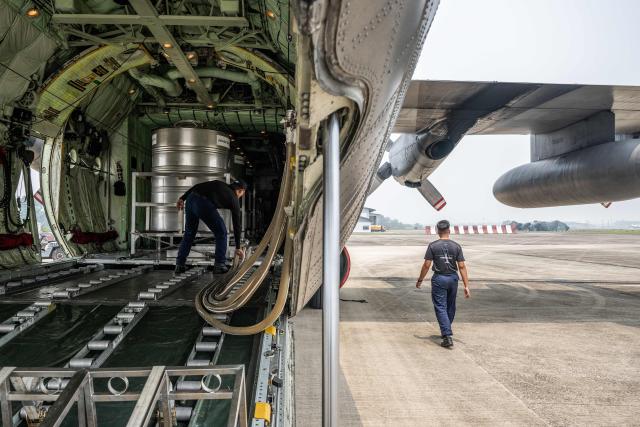 Members of the Royal Malaysian Air Force prepare a C-130 aircraft for a cloud-seeding operations at the air force base in Kuching, the capital of Sarawak state on the island of Borneo, on September 6, 2026. Malaysia launched a three-day cloud-seeding operation on September 3 in a bid to ease hazardous haze choking Sarawak state, as smoke from Indonesian forest fires pushed air quality to dangerous levels. (Photo by Mohd Rasfan / AFP)