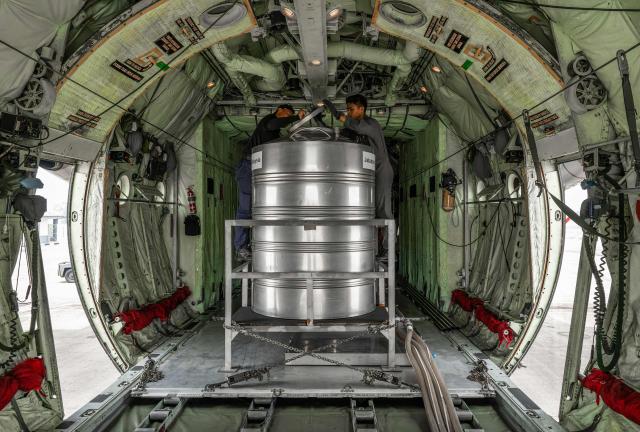 Members of the Royal Malaysian Air Force inspect a cloud-seeding tanks on a C-130 aircraft at the air force base in Kuching, the capital of Sarawak state on the island of Borneo, on September 6, 2026. Malaysia launched a three-day cloud-seeding operation on September 3 in a bid to ease hazardous haze choking Sarawak state, as smoke from Indonesian forest fires pushed air quality to dangerous levels. (Photo by Mohd Rasfan / AFP)
