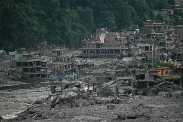 A general view shows damaged houses covered in sludge in the aftermath of flash floods in Trishuli, in Nepal's Nuwakot district on September 6, 2026. The glacial and mountain collapse on the China-Nepal border killed at least 1,384 people and left more than 5,500 missing across the two countries. (Photo by Pedro PARDO / AFP)