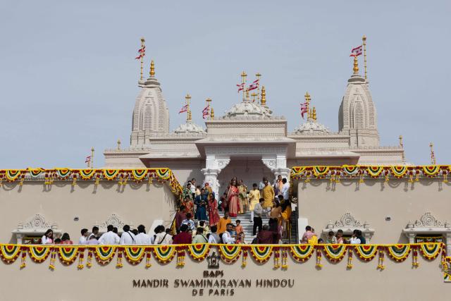 Hindu devotees gather inside the newly consecrated BAPS (Bochasanwasi Akshar Purushottam Swaminarayan Sanstha) Hindu temple in Bussy-Saint-Georges on September 6, 2026. On September 6, 2026, thousands of Hindus are celebrating the consecration of the first major temple built in France by the BAPS organization, which promotes it as 'an emblem of Indian culture and Hinduism.' Hailed as the largest Hindu temple built in continental Europe in a traditional style, the edifice stands in the new town of Bussy-Saint-Georges (Seine-et-Marne), 30 km east of the capital. (Photo by Kenzo TRIBOUILLARD / AFP)