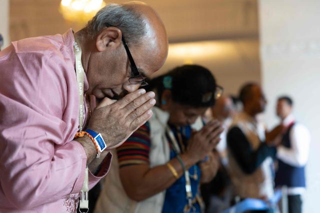 Hindu devotees offer prayers after the consecration ceremony of the BAPS (Bochasanwasi Akshar Purushottam Swaminarayan Sanstha) Hindu temple in Bussy-Saint-Georges on September 6, 2026. On September 6, 2026, thousands of Hindus are celebrating the consecration of the first major temple built in France by the BAPS organization, which promotes it as 'an emblem of Indian culture and Hinduism.' Hailed as the largest Hindu temple built in continental Europe in a traditional style, the edifice stands in the new town of Bussy-Saint-Georges (Seine-et-Marne), 30 km east of the capital. (Photo by Kenzo TRIBOUILLARD / AFP)