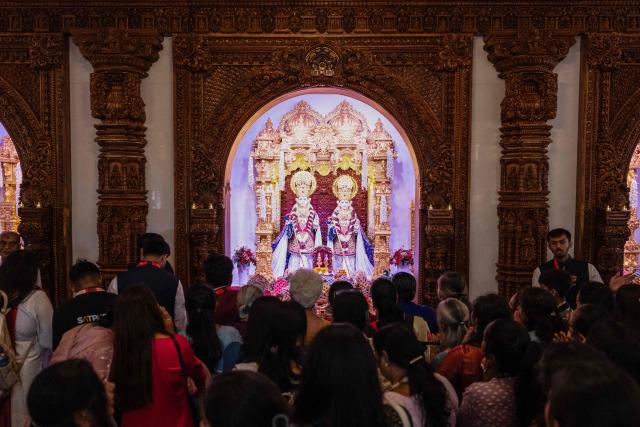 Hindu devotees offer prayers after the consecration ceremony of the BAPS (Bochasanwasi Akshar Purushottam Swaminarayan Sanstha) Hindu temple in Bussy-Saint-Georges on September 6, 2026. On September 6, 2026, thousands of Hindus are celebrating the consecration of the first major temple built in France by the BAPS organization, which promotes it as 'an emblem of Indian culture and Hinduism.' Hailed as the largest Hindu temple built in continental Europe in a traditional style, the edifice stands in the new town of Bussy-Saint-Georges (Seine-et-Marne), 30 km east of the capital. (Photo by Kenzo TRIBOUILLARD / AFP)